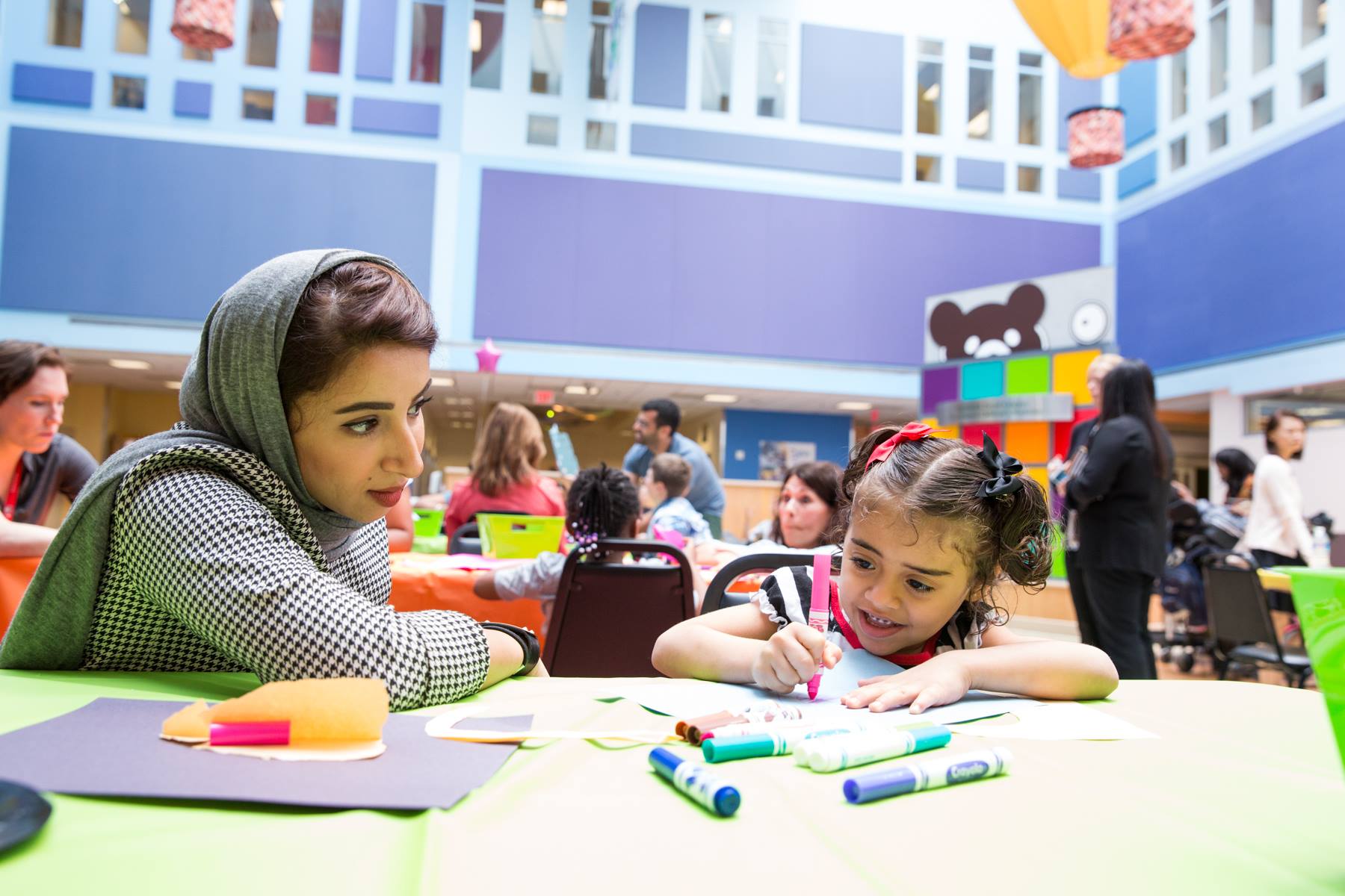 woman teaching child