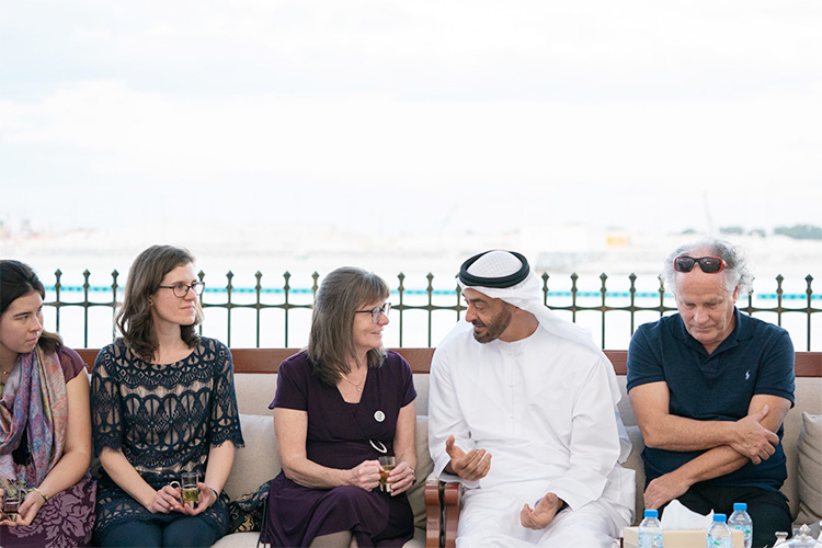 HH Sheikh Mohamed Bin Zayed Al Nahyan sitting with a group of people