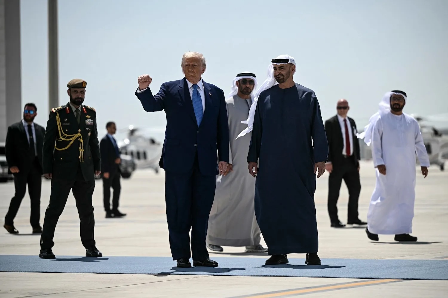 United States President Donald Trump, accompanied by his UAE counterpart Sheikh Mohamed bin Zayed Al Nahyan, gestures with a clenched fist in Abu Dhabi on May 16. Brendan Smialowski/AFP/Getty Images