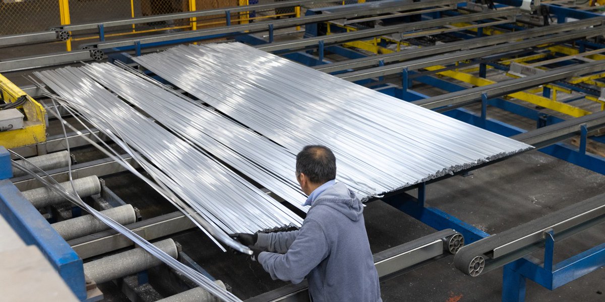 An employee works with extruded strips of aluminum at a plant in Oklahoma City.