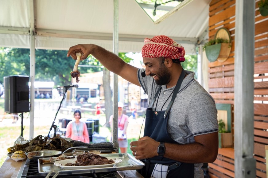 Man cooks barbecue on stage