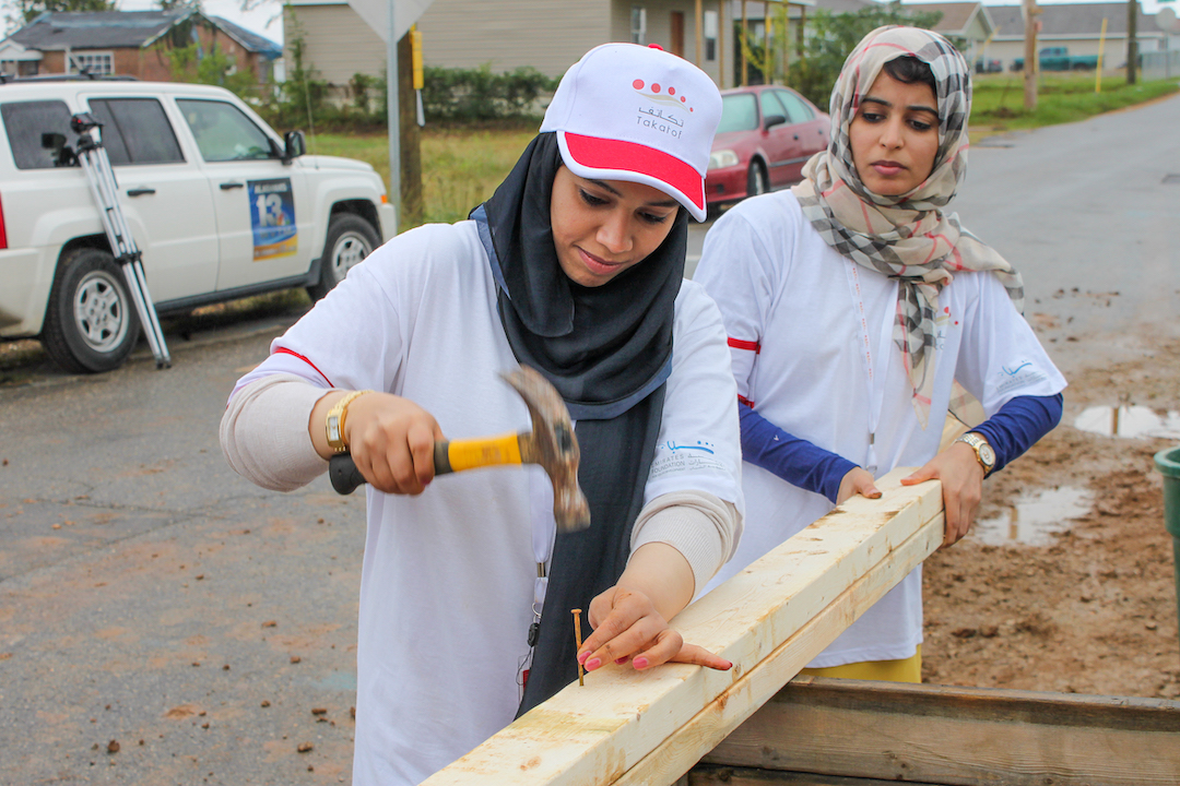 women nailing into wood