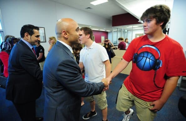 Ambassador shaking hands with student