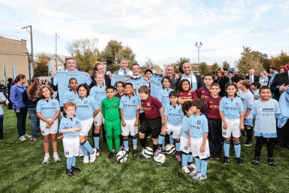 Ambassador with children in chicago playing soccer