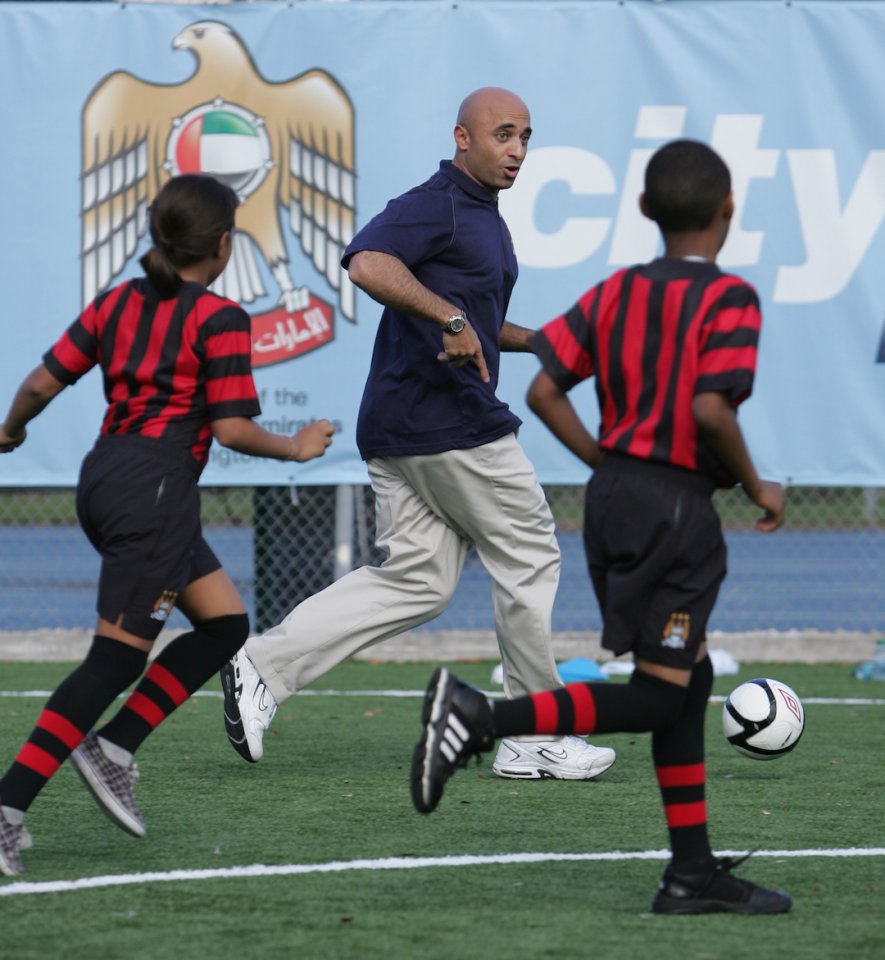Ambassador playing soccer with children