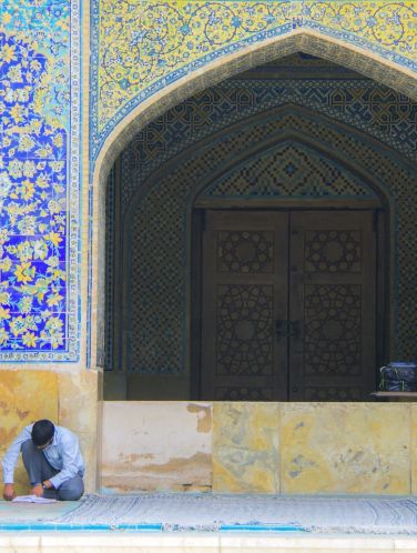 Men sitting in front of building