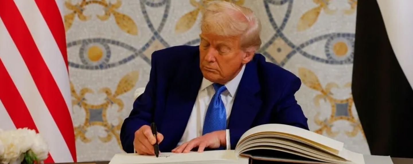 U.S. President Donald Trump signs a guest book next to United Arab Emirates President Sheikh Mohamed bin Zayed Al Nahyan, at Qasr Al Watan, in Abu Dhabi, United Arab Emirates, May 15, 2025.