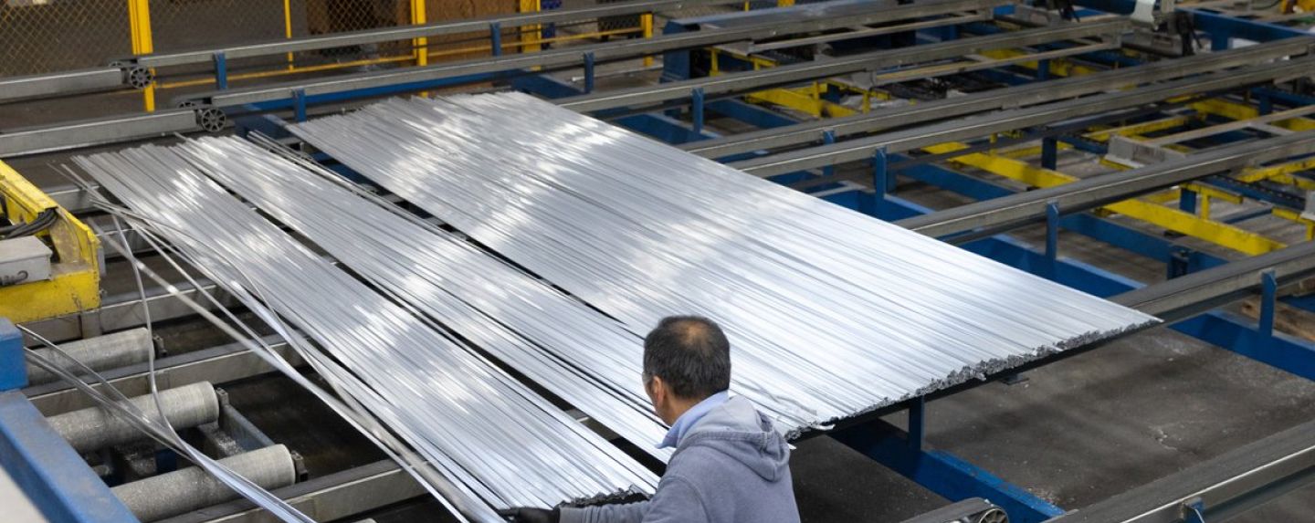 An employee works with extruded strips of aluminum at a plant in Oklahoma City.