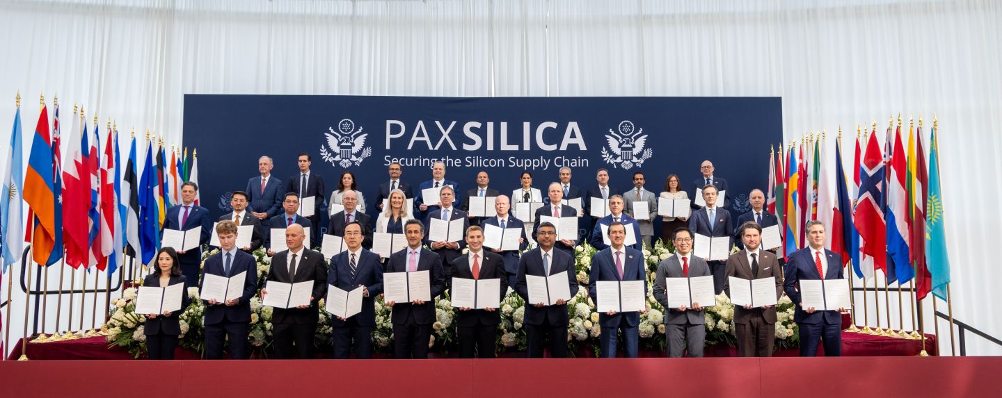 Delegates stand for a photo, each with a signed copy of the joint statement signed by thirty-five nations.