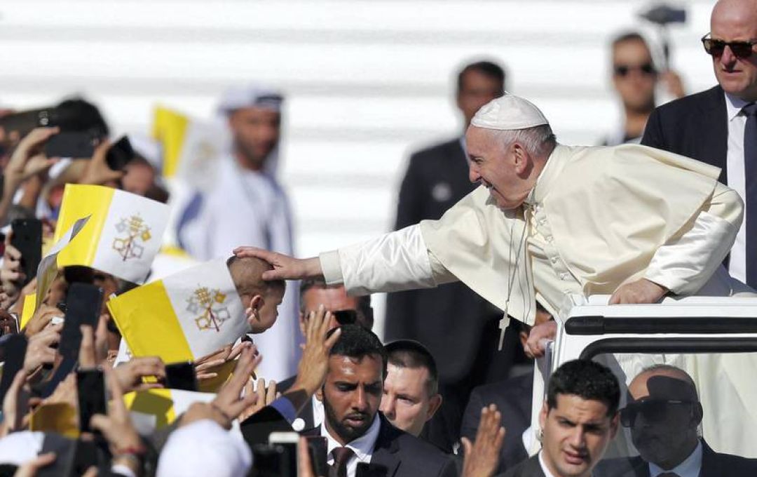 Pope Francis blesses a child. Chris Whiteoak / The National