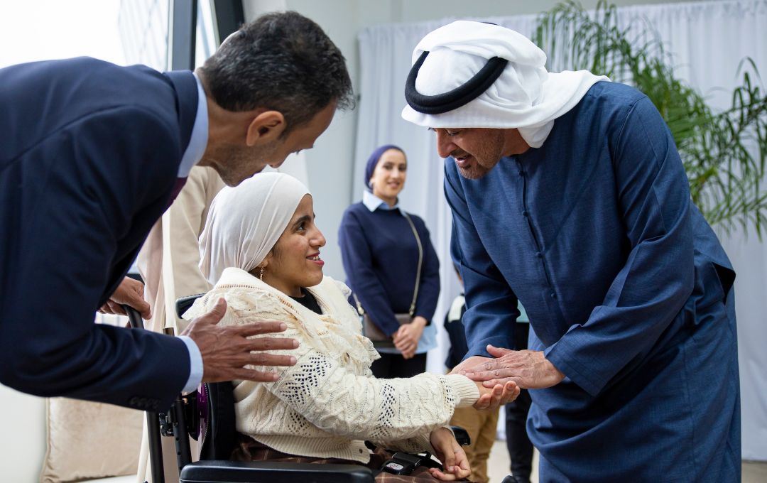 HH Sheikh Mohamed Bin Zayed Al Nahyan with a child in a wheelchair at the Children's National Hospital 