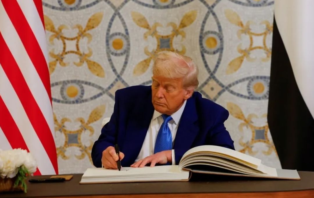 U.S. President Donald Trump signs a guest book next to United Arab Emirates President Sheikh Mohamed bin Zayed Al Nahyan, at Qasr Al Watan, in Abu Dhabi, United Arab Emirates, May 15, 2025.