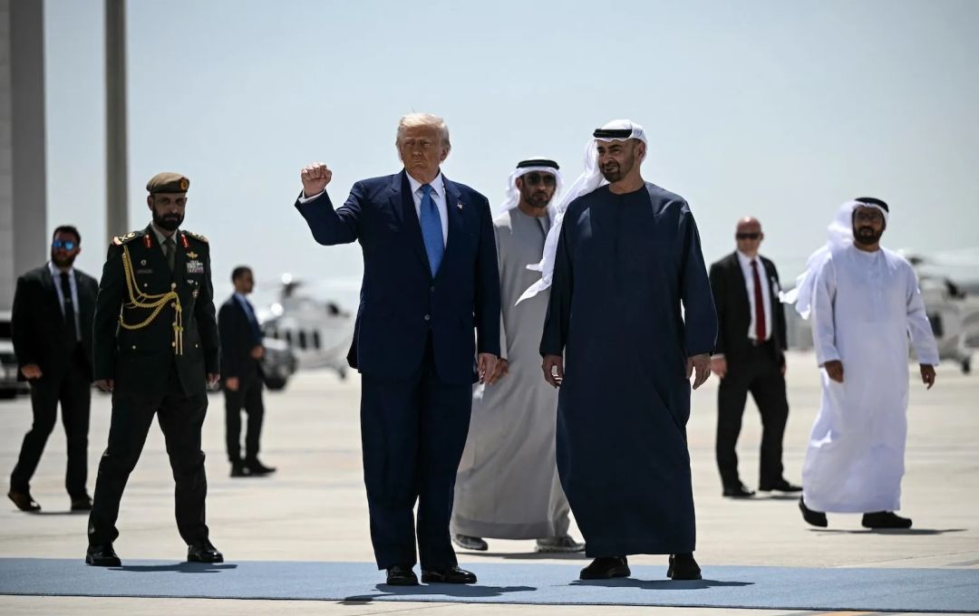 United States President Donald Trump, accompanied by his UAE counterpart Sheikh Mohamed bin Zayed Al Nahyan, gestures with a clenched fist in Abu Dhabi on May 16. Brendan Smialowski/AFP/Getty Images