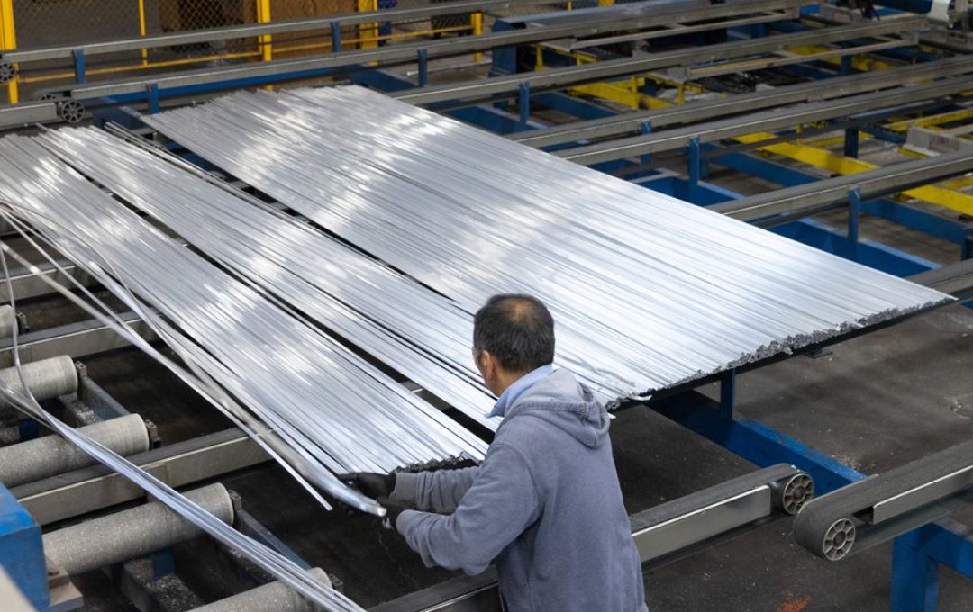 An employee works with extruded strips of aluminum at a plant in Oklahoma City.
